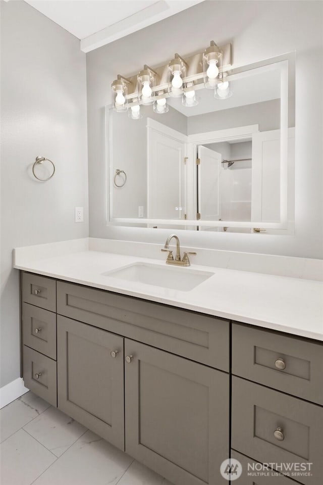 bathroom featuring marble finish floor and vanity