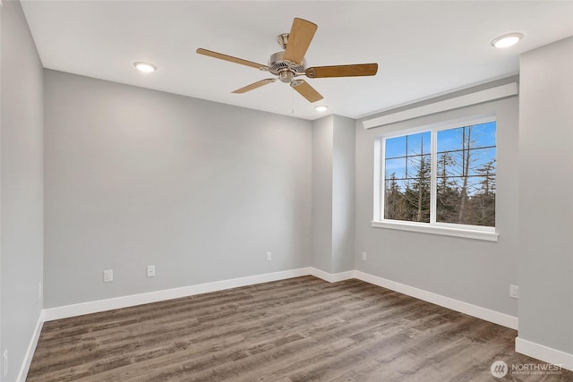 empty room with a ceiling fan, baseboards, and wood finished floors