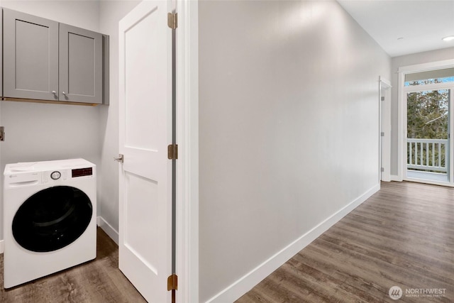 laundry room with washer / dryer, wood finished floors, cabinet space, and baseboards