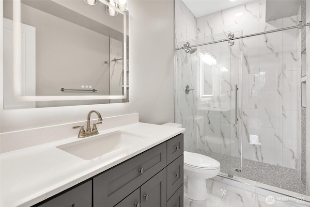 bathroom with a marble finish shower, toilet, marble finish floor, and vanity