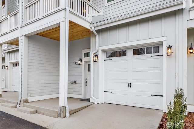 exterior space with a balcony, an attached garage, and board and batten siding