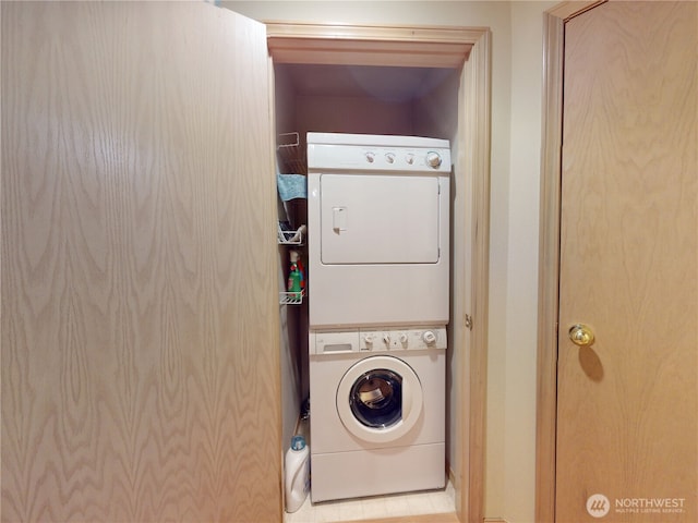 laundry room with stacked washer and clothes dryer and laundry area