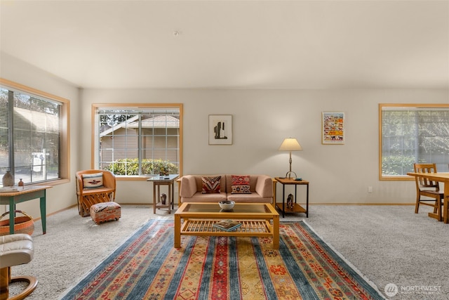 carpeted living area with baseboards