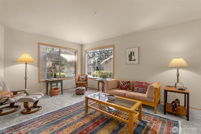 carpeted living room with baseboards