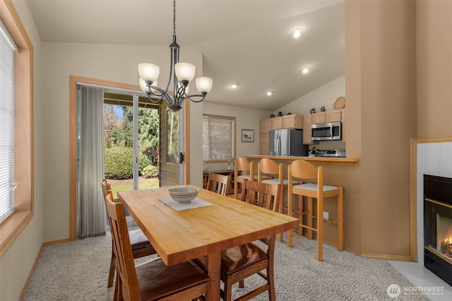 dining space featuring baseboards, a chandelier, lofted ceiling, light carpet, and recessed lighting