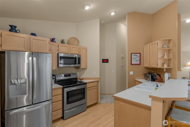 kitchen featuring open shelves, a sink, light brown cabinetry, light countertops, and stainless steel appliances