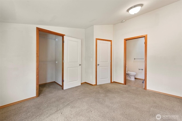 unfurnished bedroom featuring a closet, carpet flooring, baseboards, and vaulted ceiling