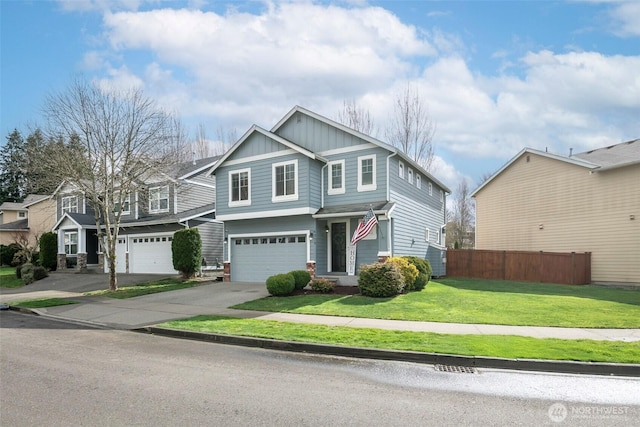 view of front of house featuring fence, a front lawn, concrete driveway, a garage, and board and batten siding