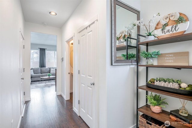 corridor featuring recessed lighting, baseboards, and dark wood-style flooring