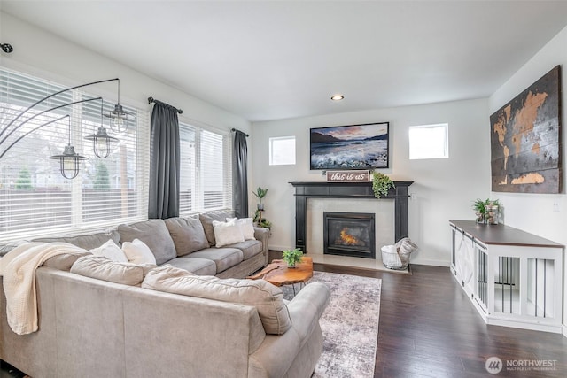 living room with recessed lighting, dark wood-style floors, baseboards, and a tile fireplace