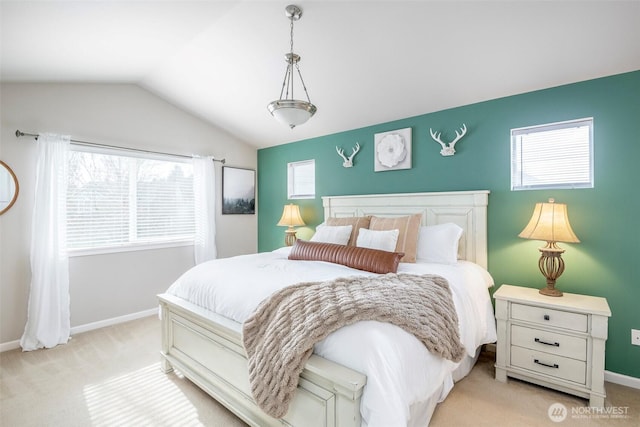 bedroom with light carpet, baseboards, and lofted ceiling