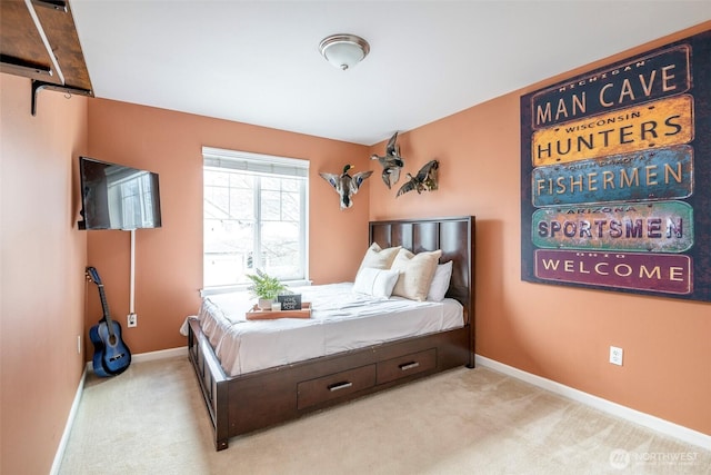 bedroom with light colored carpet and baseboards