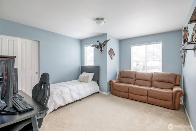 carpeted bedroom with baseboards