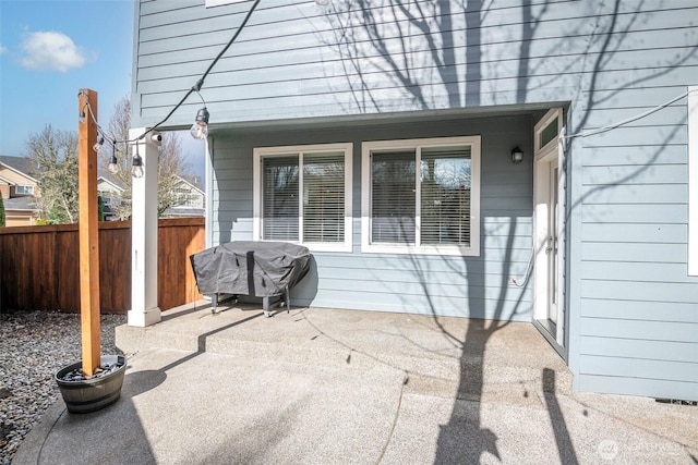 view of patio / terrace featuring grilling area and fence