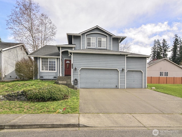 view of front facade with concrete driveway, an attached garage, fence, and a front yard