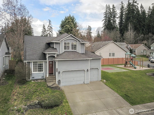 traditional-style home with a front yard, fence, driveway, an attached garage, and a playground