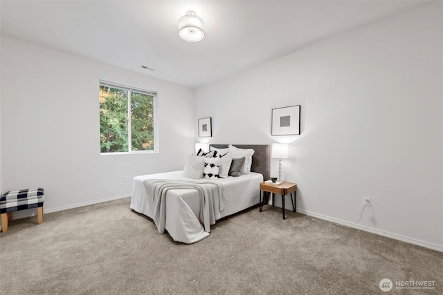 carpeted bedroom with visible vents and baseboards