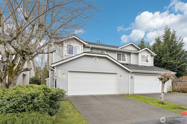 view of front of property with driveway, a garage, and roof with shingles