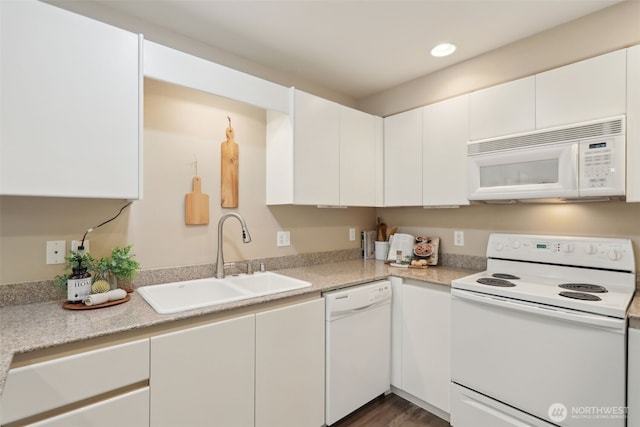 kitchen with a sink, white cabinetry, recessed lighting, white appliances, and light countertops