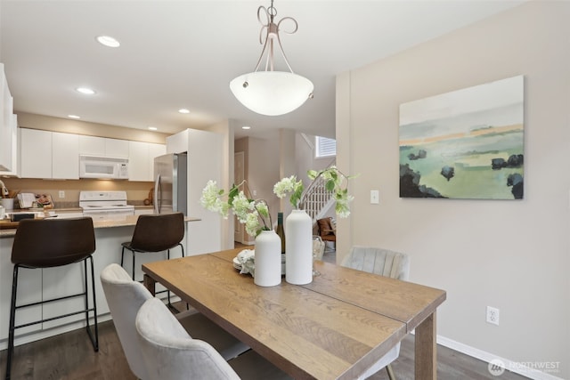 dining space with recessed lighting, baseboards, and dark wood-style flooring