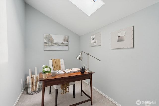 carpeted office featuring baseboards and vaulted ceiling with skylight