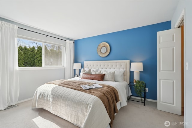 carpeted bedroom featuring visible vents and baseboards