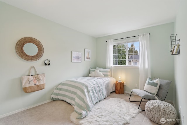 bedroom with baseboards and carpet