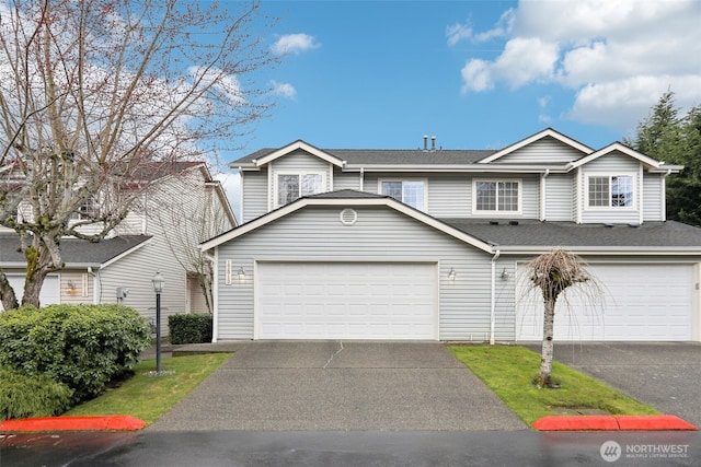 view of front of house with aphalt driveway and a shingled roof