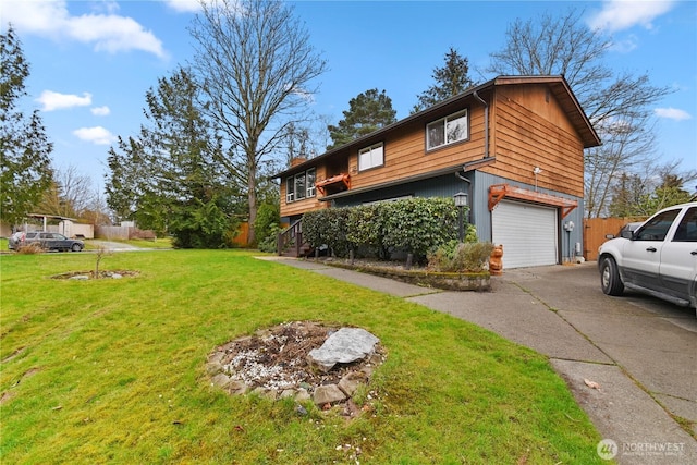 view of home's exterior with a garage, a yard, driveway, and fence