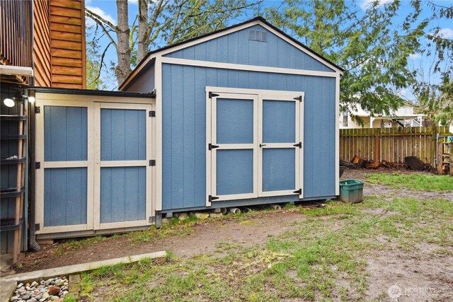 view of shed with fence