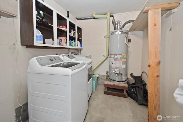 clothes washing area featuring laundry area, separate washer and dryer, and water heater