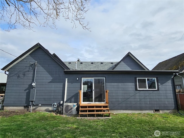 back of house featuring entry steps, a yard, and ac unit