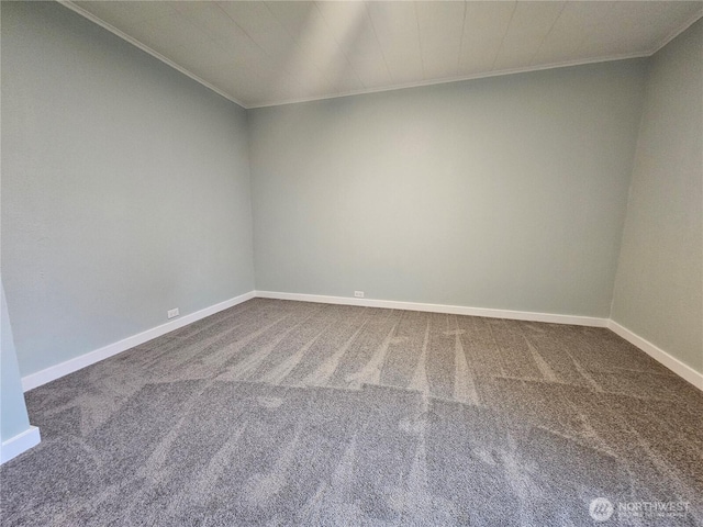 empty room featuring carpet flooring, baseboards, and ornamental molding