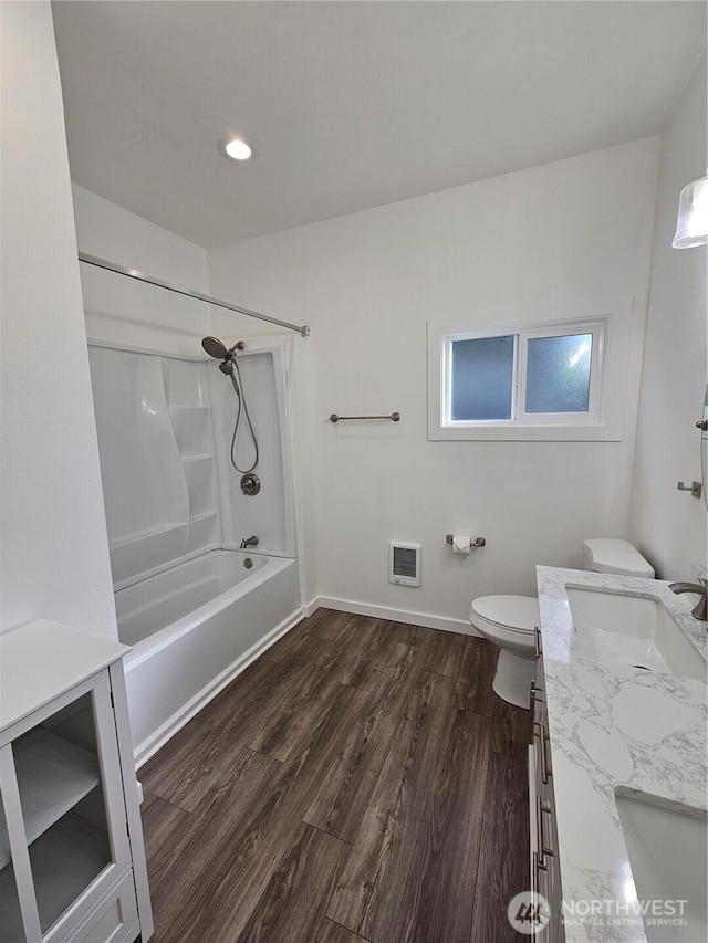 full bathroom with baseboards, toilet, shower / bath combination, wood finished floors, and vanity