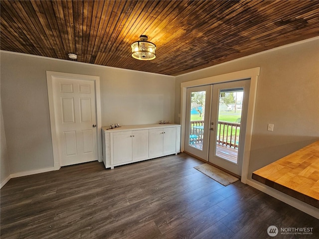 unfurnished dining area with french doors, wooden ceiling, baseboards, and dark wood-style flooring