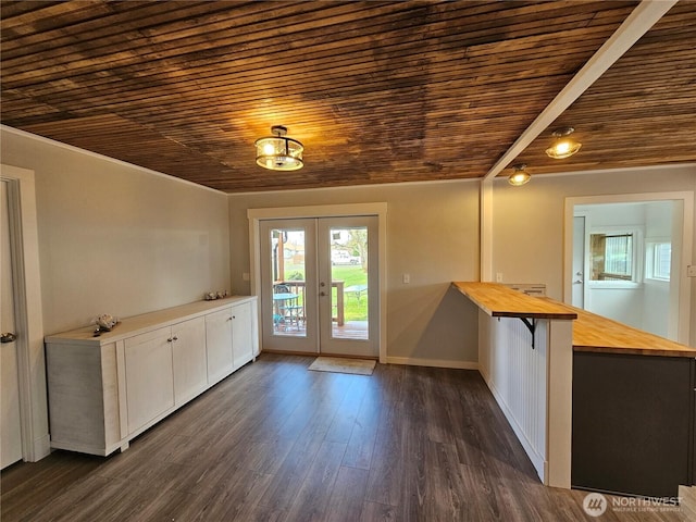 interior space with french doors, baseboards, dark wood-style floors, and wooden ceiling