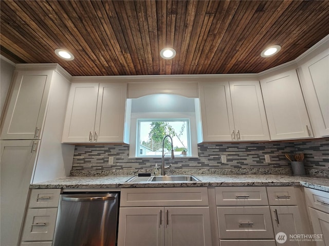 kitchen with dishwasher, decorative backsplash, white cabinetry, and a sink