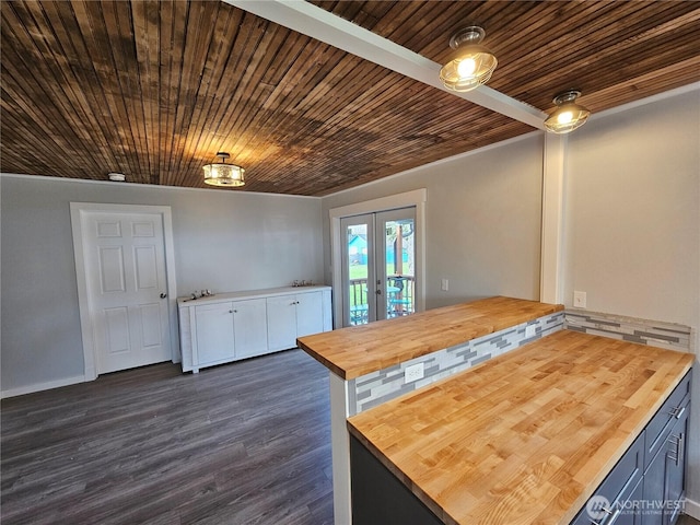 kitchen with dark wood finished floors, butcher block counters, wood ceiling, french doors, and white cabinets