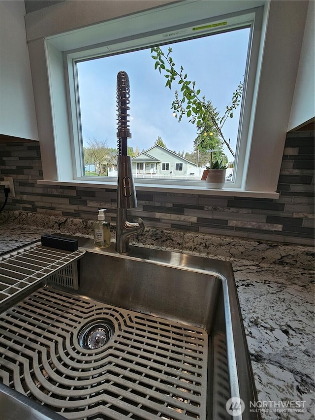 room details with a sink and decorative backsplash