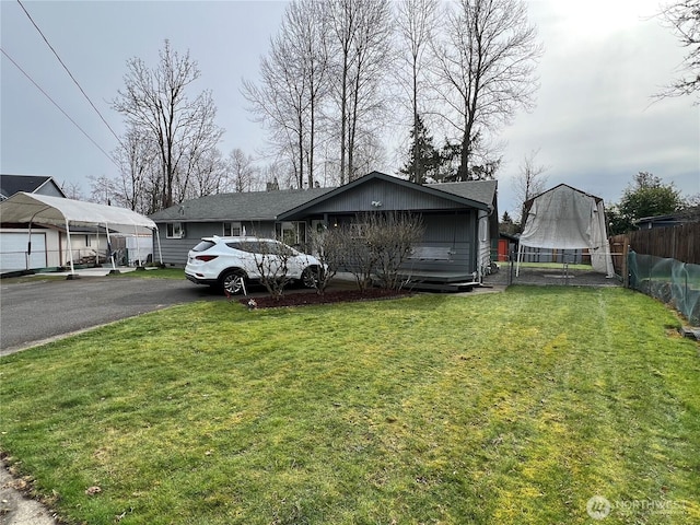 view of front of house with a front yard and fence