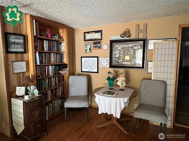 sitting room with a textured ceiling and wood finished floors