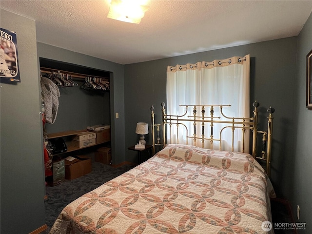 bedroom with a closet, carpet floors, and a textured ceiling