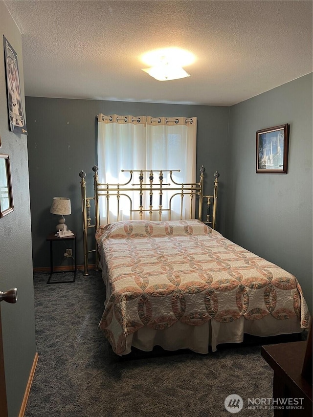 bedroom with carpet flooring and a textured ceiling