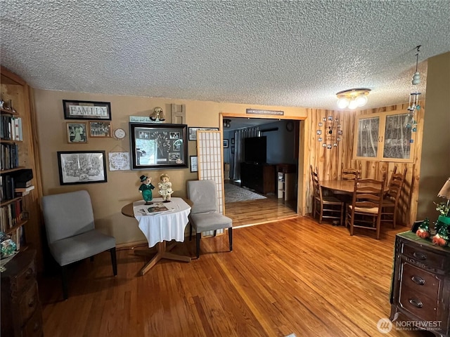 sitting room with a textured ceiling and wood finished floors