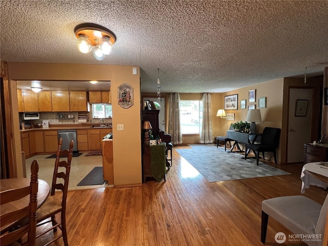 living room featuring light wood-style flooring and a textured ceiling