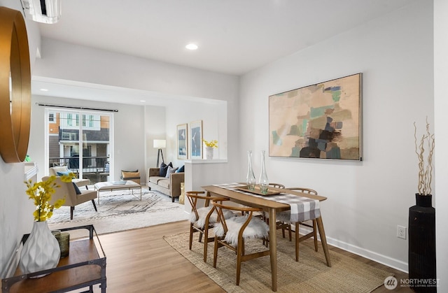 dining area featuring recessed lighting, baseboards, and wood finished floors