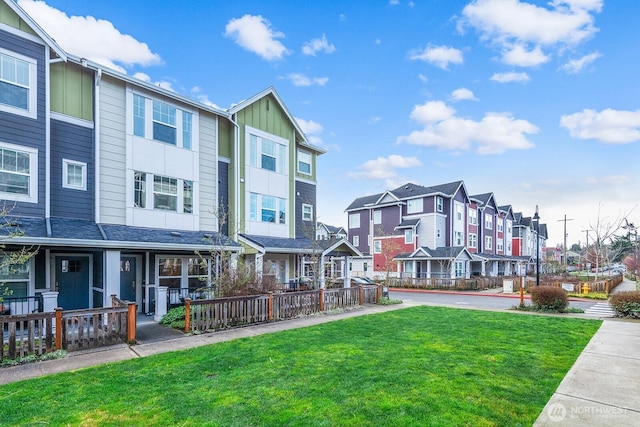 view of community featuring a lawn and a residential view