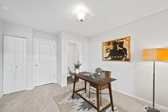 carpeted office featuring baseboards