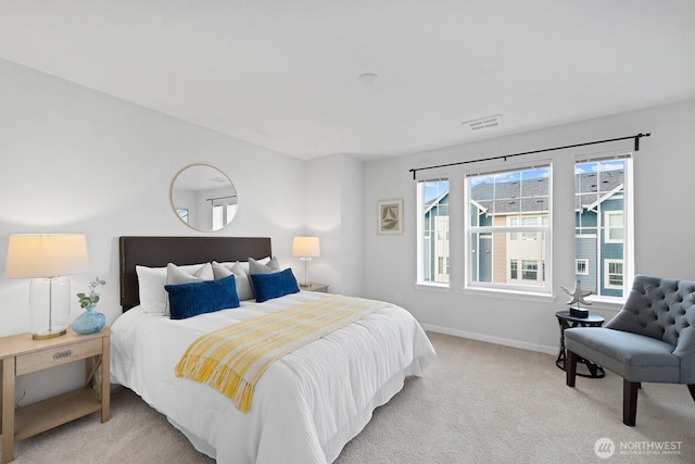 carpeted bedroom with visible vents and baseboards