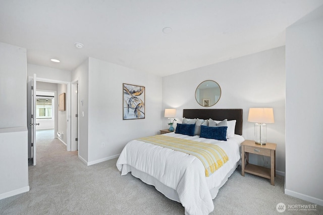 bedroom with light carpet and baseboards